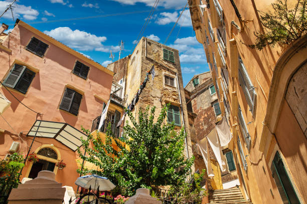 Washed laundry is dried on clothesline in Corfu, Greece. The washed laundry is dried on the clothesline in narrow streets of Kerkyra, Island of Corfu, Greece. corfu town stock pictures, royalty-free photos & images