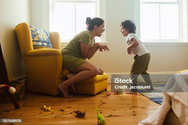 Mother And Son Imitating A Dinosaur At Home Stock Photo - Download Image Now - Child, Playing, Playful