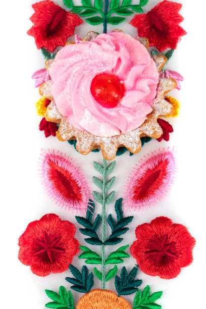 istock Beautiful cake on a bright floral fabric isolated on a white background. 1357658107