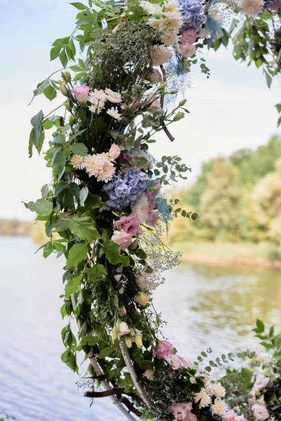 istock Circle wedding arch decorated with flowers and greenery outdoors, copy space. Wedding setting. Floral composition 1357658285