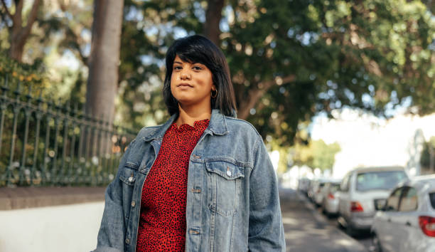 istock Woman looking at the camera while standing outdoors 1357658632
