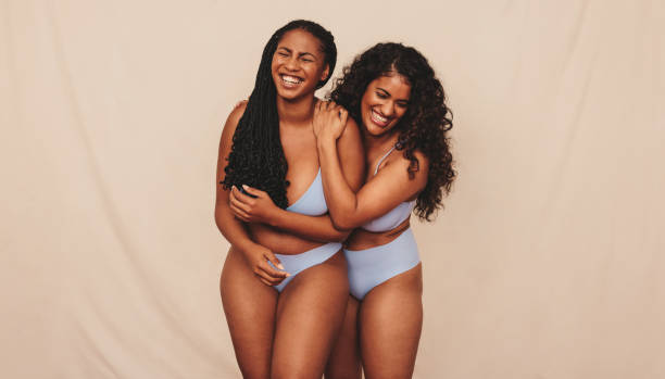 istock Best friends embracing their natural bodies in a studio 1357659816