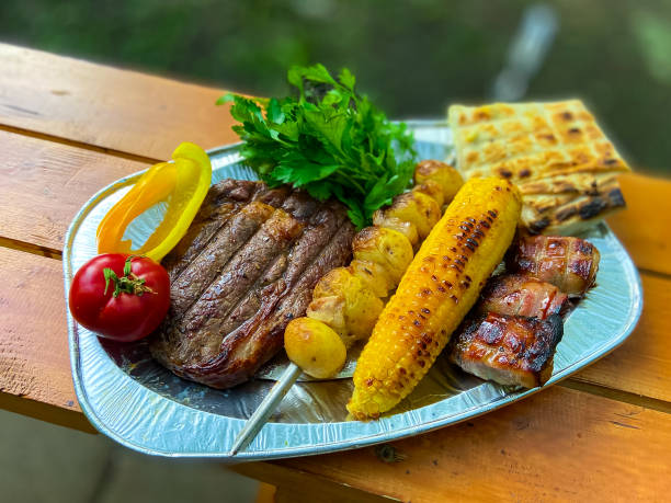 istock grilled beef steak, potatoes, corn, vegatables on plate 1357659981