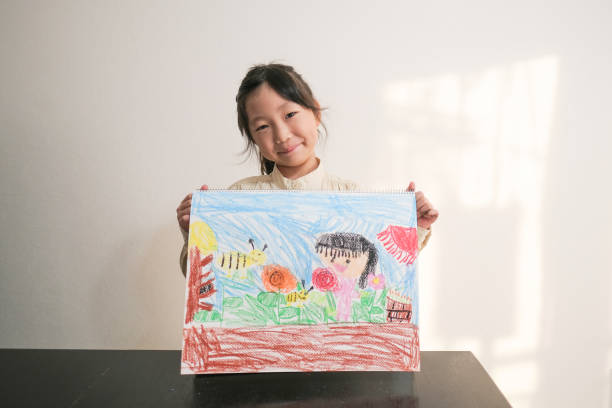 Girl showing painting Education of Child crayon drawing photos stock pictures, royalty-free photos & images