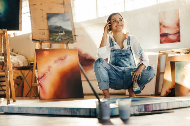 istock Thoughtful young artist smiling in her studio 1357660906