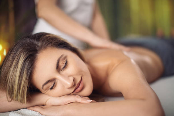 istock Attractive young woman receiving relax back massage 1357660966