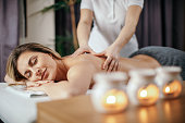 Attractive young woman receiving relax back massage