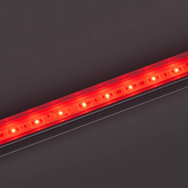 istock Bright red LED flood light bar on dark background 1357662247