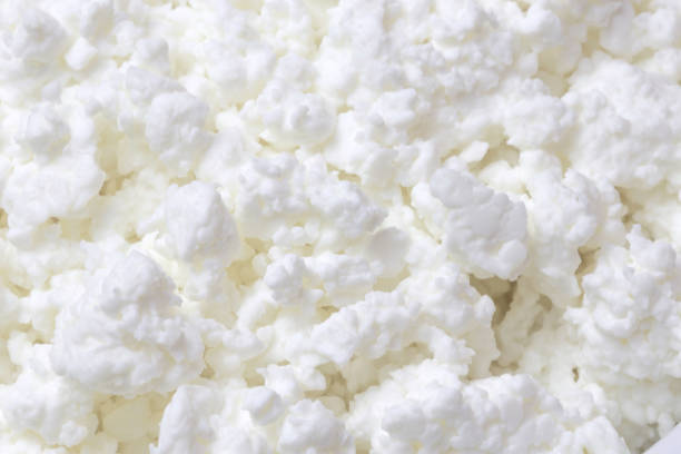 Dairy product farm, food background, texture of cottage cheese close-up Dairy product farm, food background, texture of cottage cheese close-up. cottage cheese photos stock pictures, royalty-free photos & images