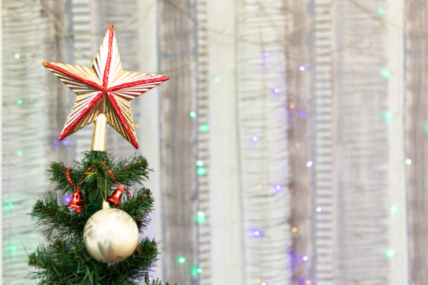 istock New Year tree with green branches and needles with Christmas decorations on the background of garlands on New Years Eve. Selective focus 1357664785