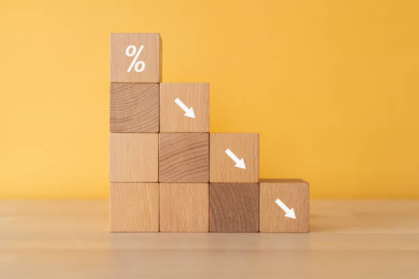 Wooden cubes stacked like a ladder printed with percentage and arrows