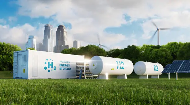 Photo of Concept of an energy storage system based on electrolysis of hydrogen in a clean environment with photovoltaics, wind farms and a city in the background. 3d rendering.