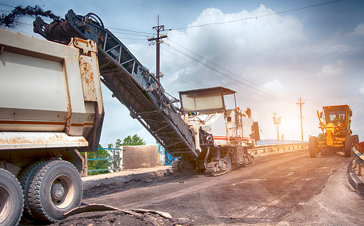 Large milling machine removing an old pavement layers at full depth