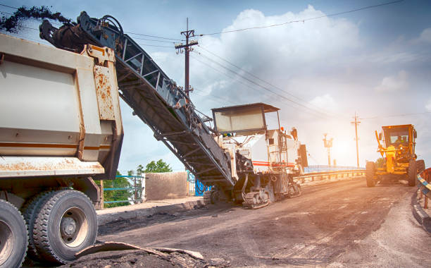 milling machine removing Large milling machine removing an old pavement layers at full depth milling machine stock pictures, royalty-free photos & images