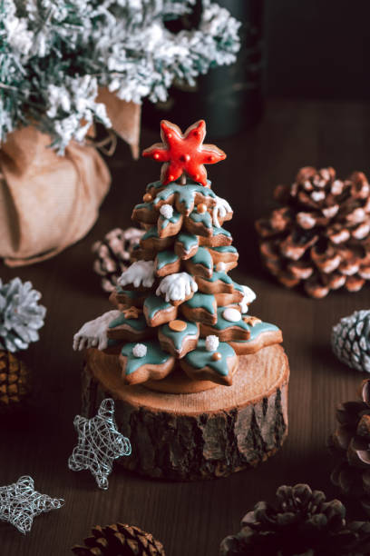 istock Gingerbread Christmas tree on dark table, Christmas card 1357666497