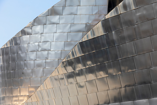 Bilbao, Spain - August 2, 2021: close-up of the facade of the Guggenheim Museum Bilbao, a museum of modern and contemporary art, designed by architect Frank Gehry in 1997