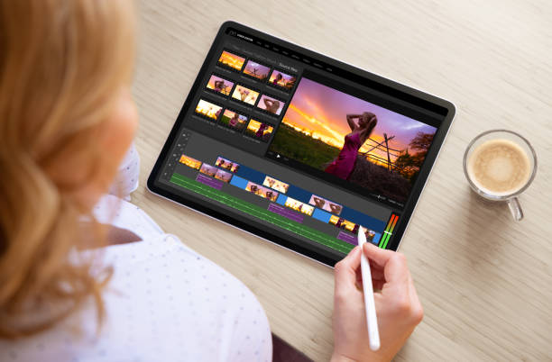 istock Woman editing video footage on tablet computer 1357667975