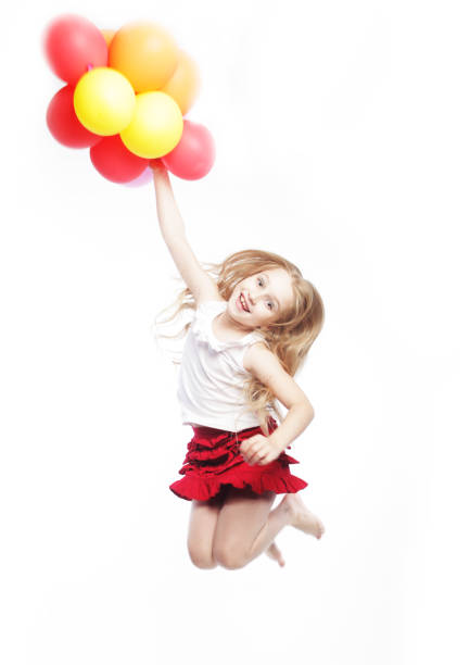 Little girl jump with balloons