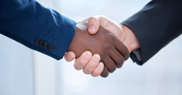istock Shot of two unrecognizable businesspeople shaking hands at work 1357671109