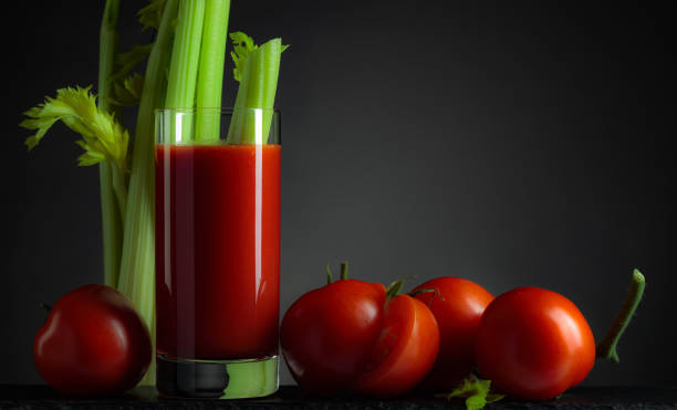 istock Tomato juice with tomatoes and celery sticks. 1357675887