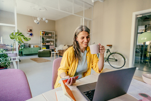 Photo of a smiling woman working from home