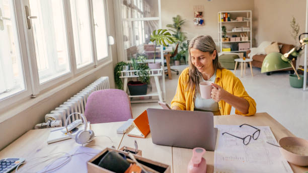 istock Smiling woman working from home 1357676926