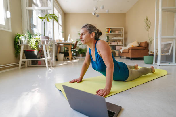 istock Woman doing yoga at home 1357677251