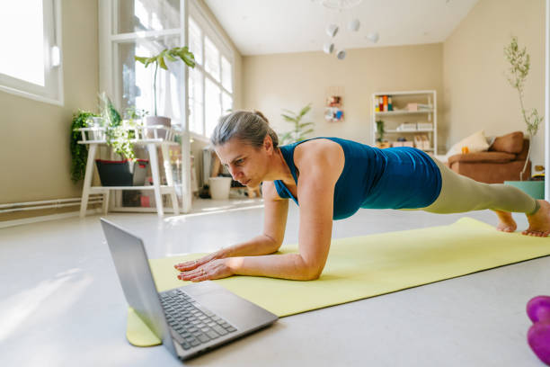 istock Woman exercising at home 1357677279
