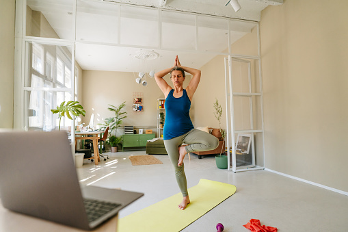 Photo of a woman doing yoga at home