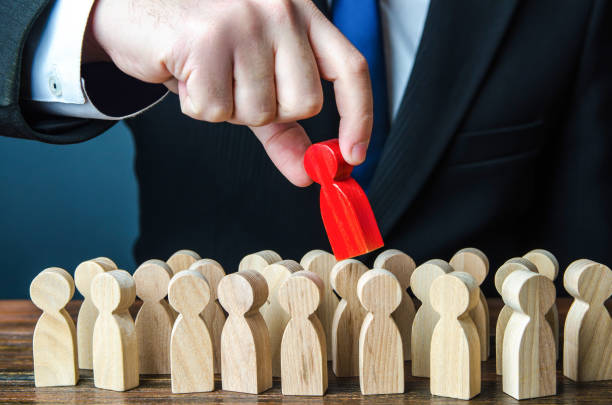 istock Man pulls the red man out of the crowd. Different, special. Infected. Intruder detection. Collective immunity. Dissent, disagreement. Repression. Find the right candidate for the job 1357678072