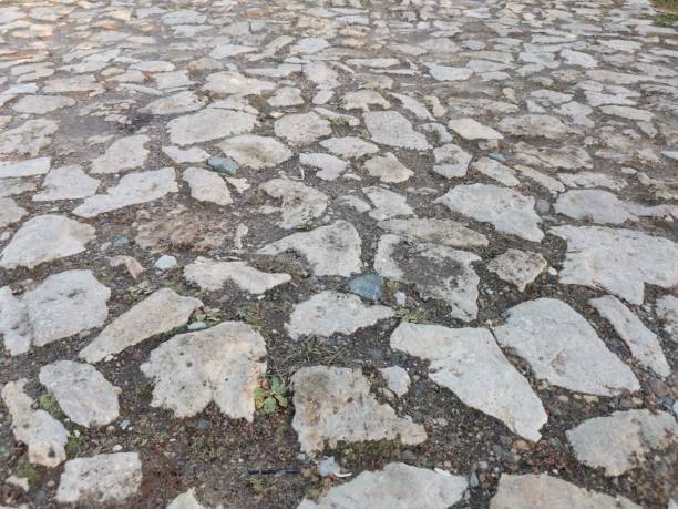 istock the old road is paved with natural stone. grey background 1357679406