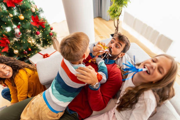 istock Parents playing with children while spending Christmas day at home 1357679458