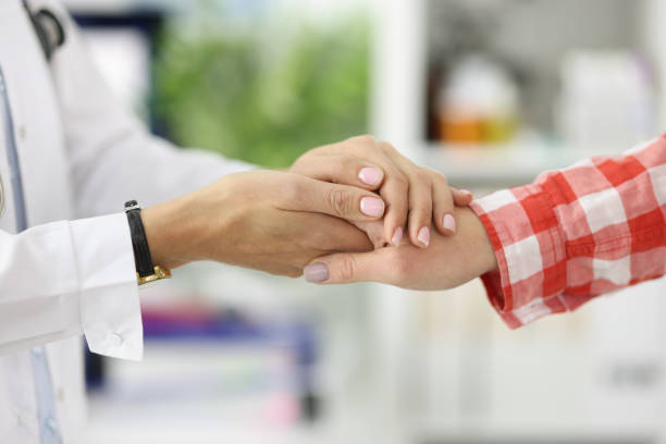 istock Handshake between doctor and patient in medical office. 1357680001