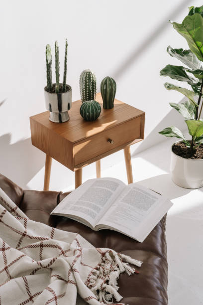 istock Open book on armchair in cozy home 1357680139