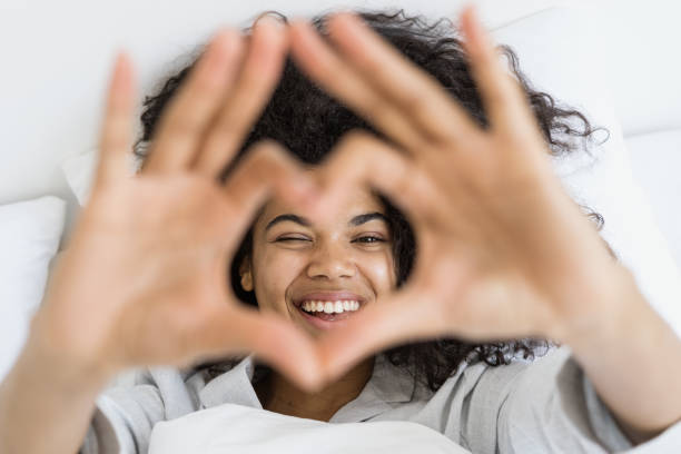istock Afro american woman showing heart shape with hands 1357680143