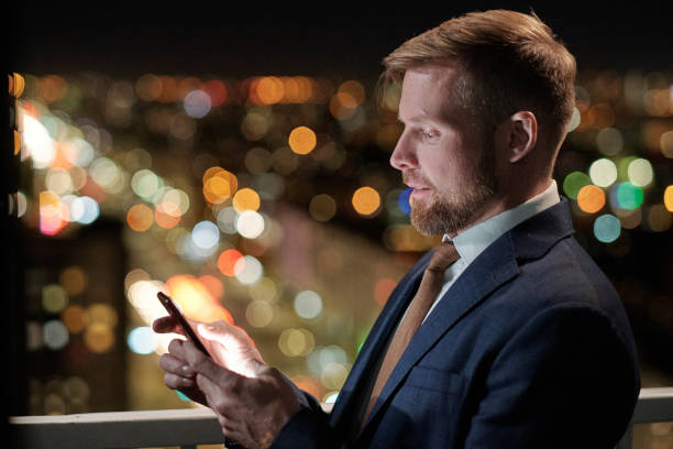 istock Confident businessman looking at smartphone screen during communication 1357681593