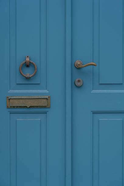 istock Blue front door with bronze knocker handler in Stavanger City. 1357684309