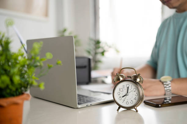 istock Alarm clock on office desk, time to work. 1357686403