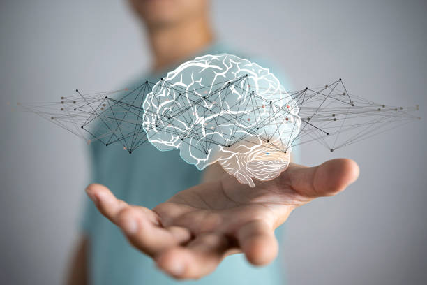 istock Businessman holding digital human brain with cell 1357686405