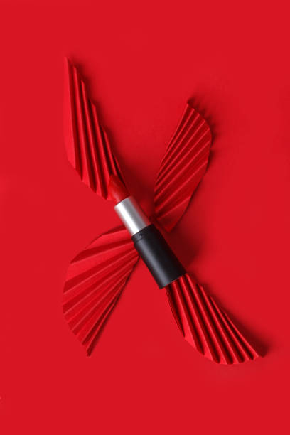 istock Red lipstick with paper craft on red background. 1357693520
