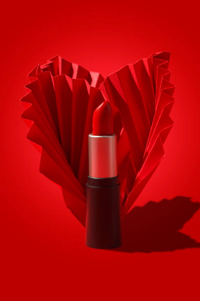 istock Red lipstick with paper craft on red background. 1357693521