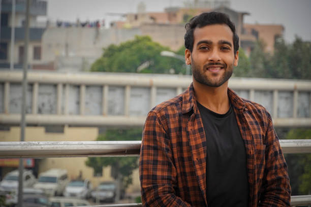 istock Indian man on bridge giving a smile and watching camera 1357694761