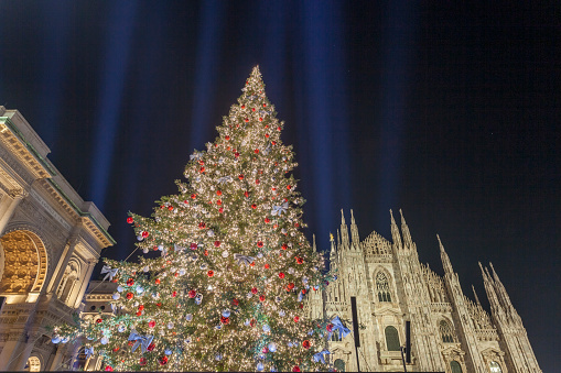 Milan, Italy - December 7, 2021: night street view of Milan with Christmas decorations in Piazza del Duomo.