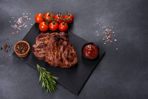 istock grilled beef steaks with spices on a dark cutting board 1357697717