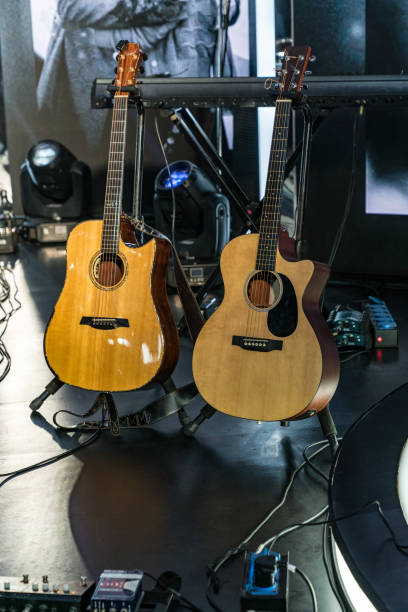 istock Two acoustic guitars on stage 1357698888