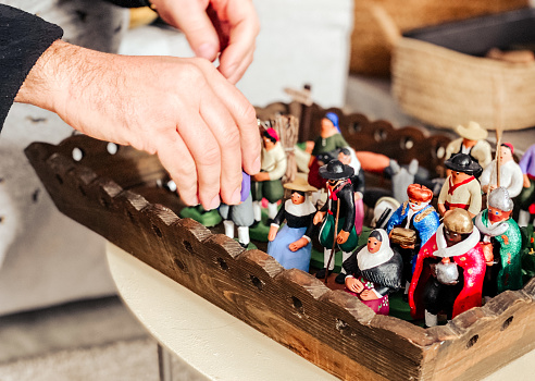 hand holding the nativity figures prepared to place