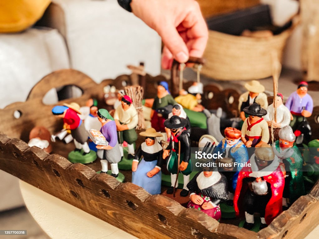 nativity figures prepared to place hand holding the nativity figures prepared to place Figurine Stock Photo