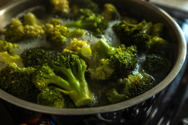 istock Frozen green broccoli florets inside pan casserole boiling closup 1357704270