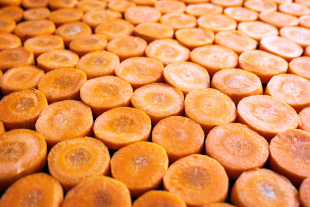istock Fresh carrot slices closeup background 1357704287