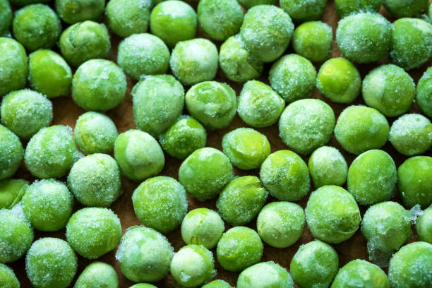 istock frozen frosty green peas background closeup 1357704425